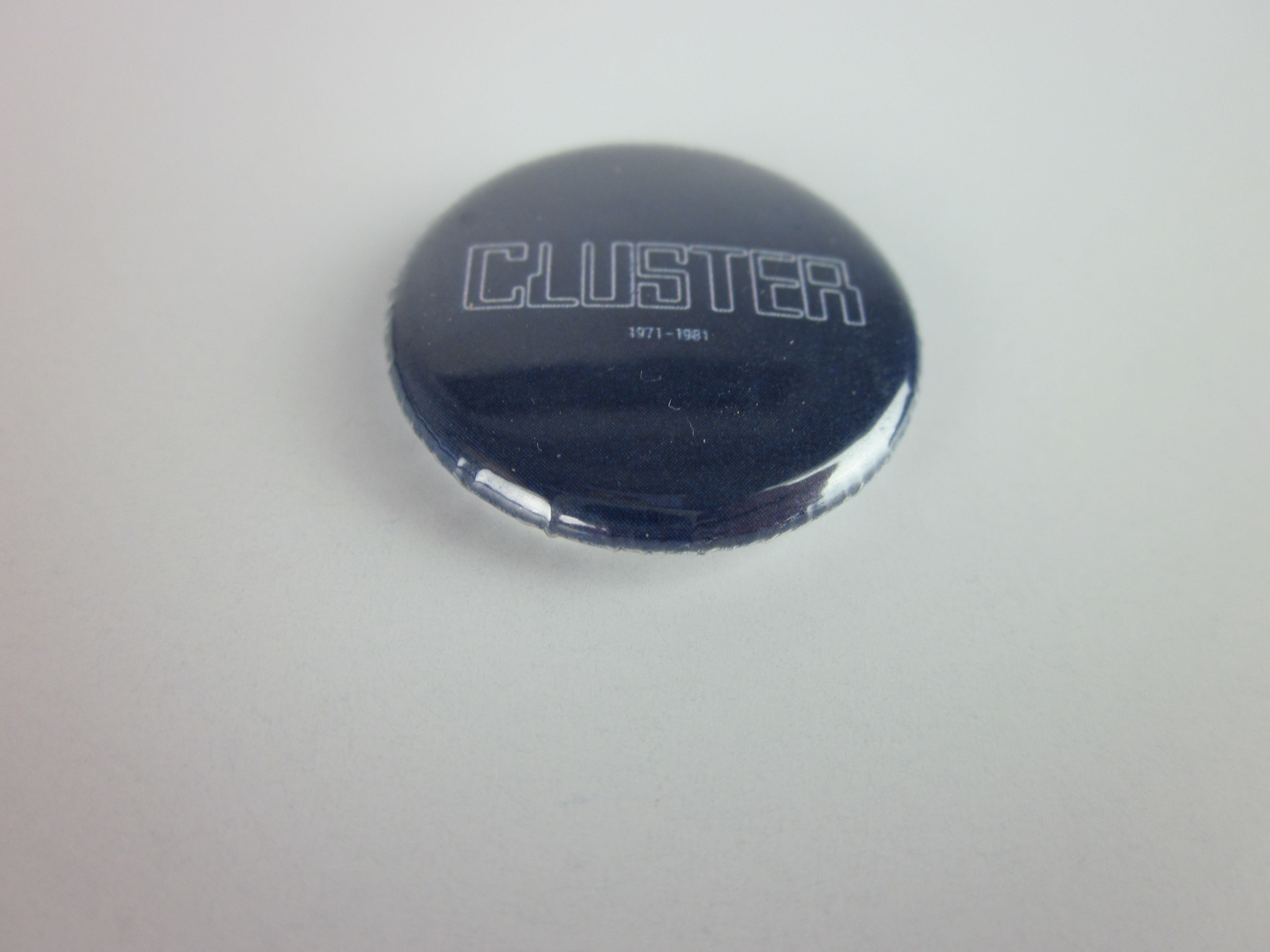 Cluster 1971-1981 Button